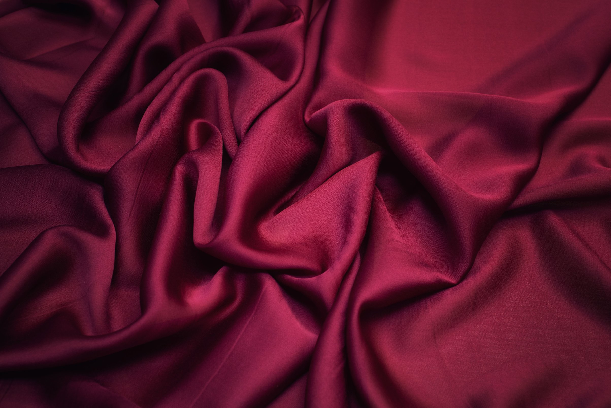 The texture of silk fabric color Marsala. Background, pattern, chiffon.